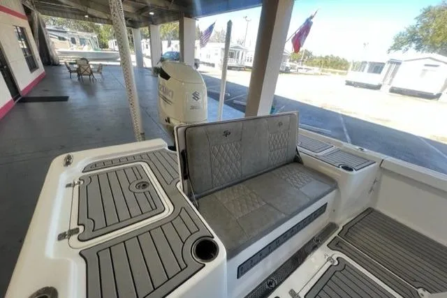 Slide: The Image of 2021 Seapro 248 boat interior with cushioned seating and deck details. - 16