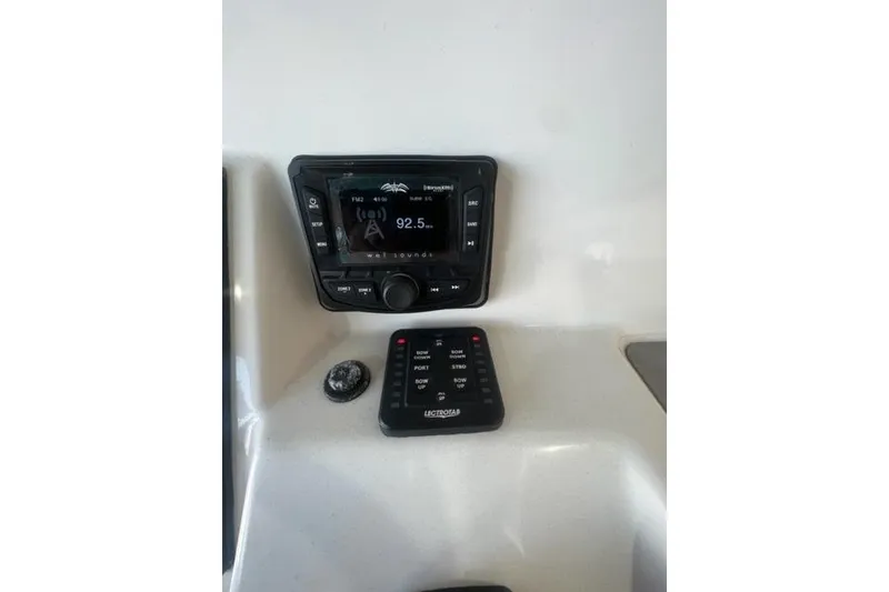 Slide: The Image of 2021 Seapro 248 boat dashboard with radio and control panel. - 18
