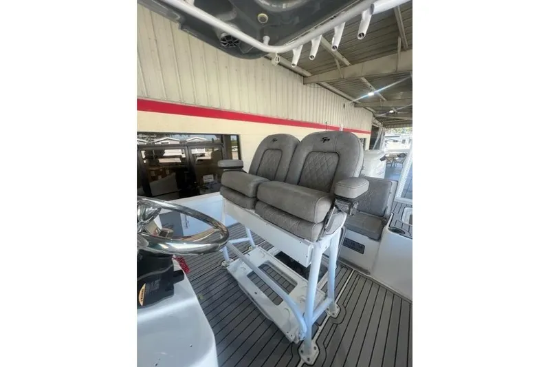 Slide: The Image of 2021 Seapro 248 boat with dual cushioned seats and steering wheel in a covered area. - 22