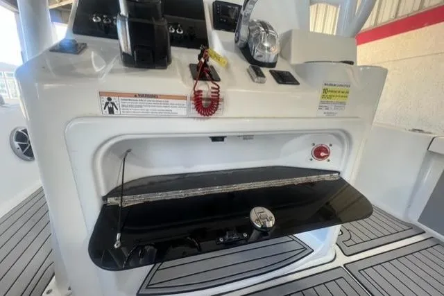 Slide: The Image of 2021 Seapro 248 boat console with controls and storage compartment. - 23