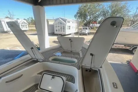 Slide: The Image of 2021 Seapro 248 boat with open storage compartments and deck view. - 25