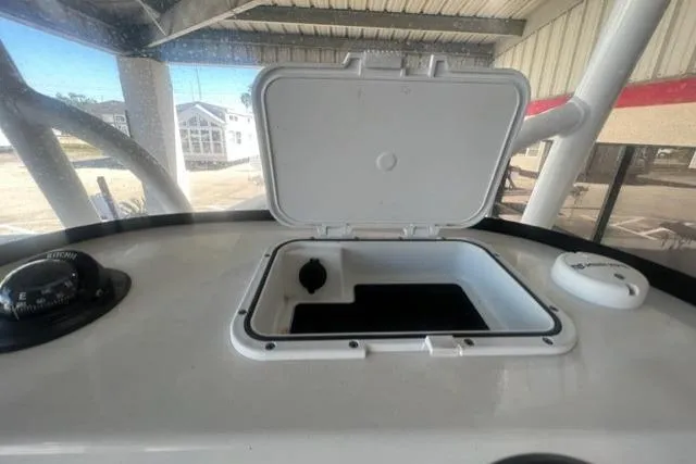 Slide: The Image of 2021 Seapro 248 boat dashboard with open storage compartment and compass. - 26