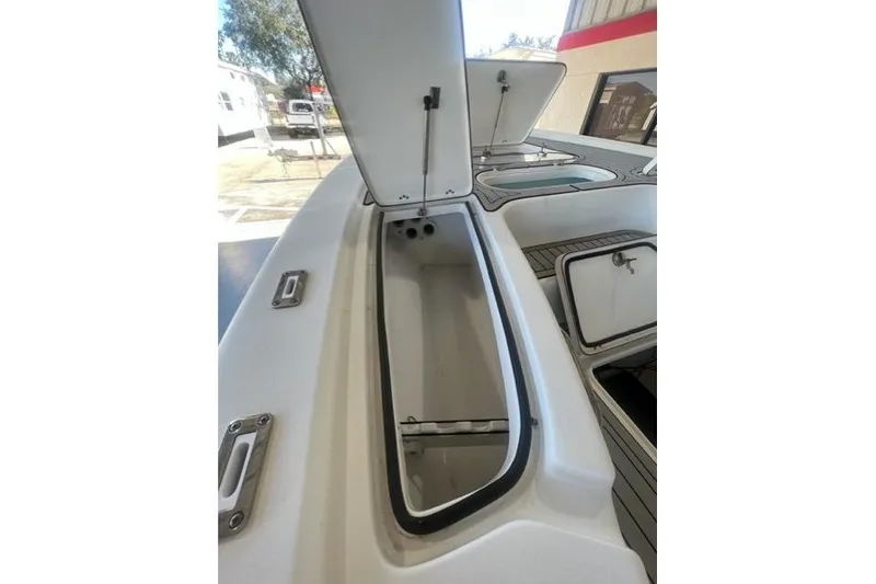 Slide: The Image of 2021 Seapro 248 boat storage compartments with open hatches, showcasing interior space. - 27