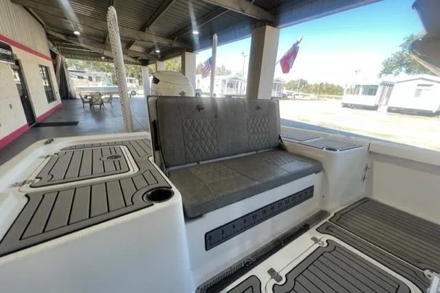 Slide: The Image of 2021 Seapro 248 boat interior with cushioned seating and non-slip flooring. - 28