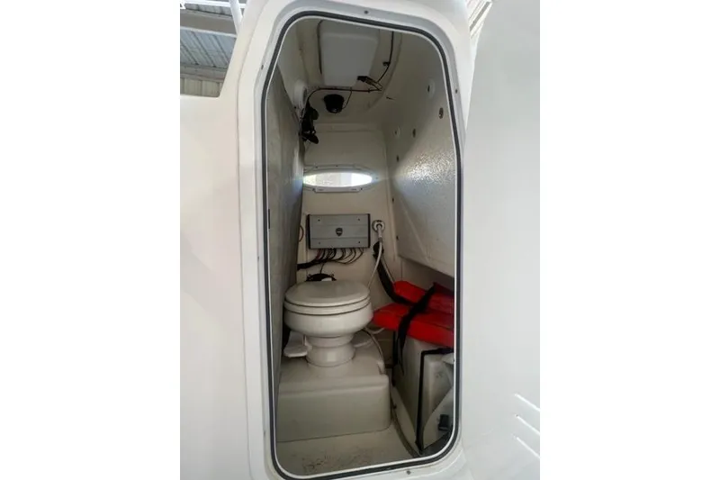 Slide: The Image of Interior of 2021 Seapro 248 boat featuring a compact marine toilet. - 29