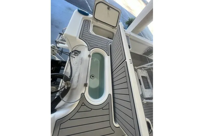 Slide: The Image of 2021 Seapro 248 boat deck with storage compartments and sleek design. - 33