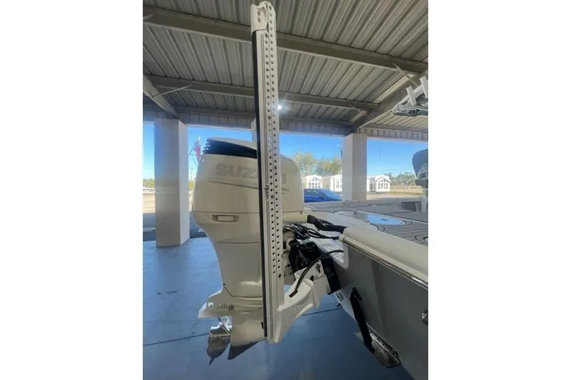 Slide: The Image of 2021 Seapro 248 boat with Suzuki outboard motor in a covered area. - 5