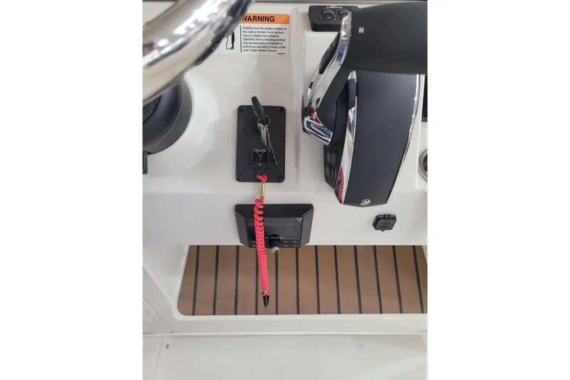 Slide: The Image of 2025 Ranger 2360 Bay boat control panel with steering wheel and throttle. - 10