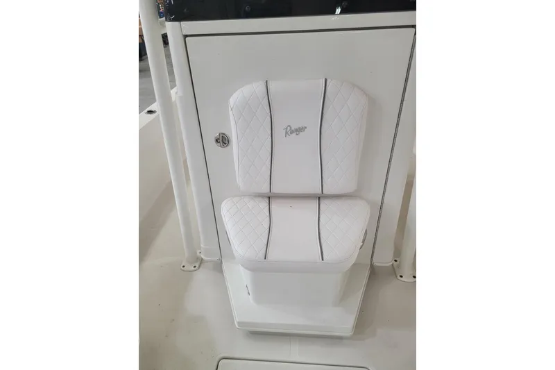 Slide: The Image of White cushioned seat on 2025 Ranger 2360 Bay boat, featuring diamond stitching. - 11