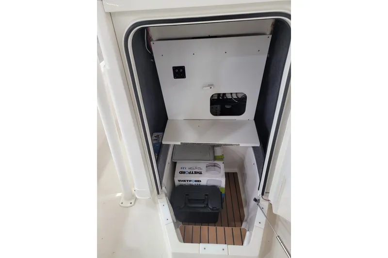 Slide: The Image of Storage compartment of 2025 Ranger 2360 Bay boat with equipment and supplies. - 12
