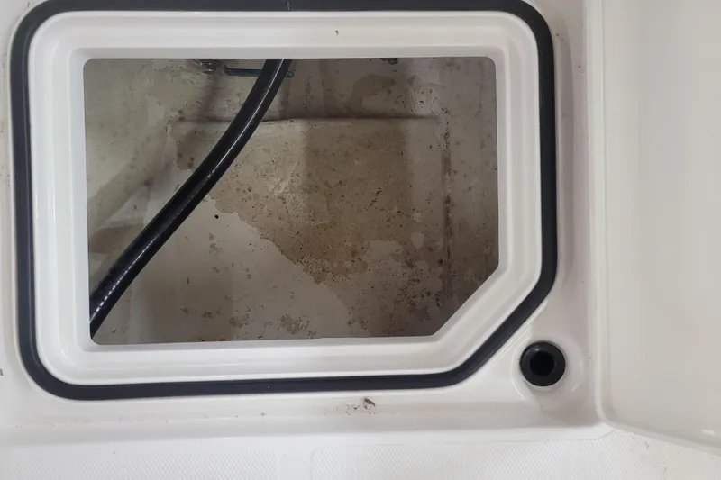 Slide: The Image of Open storage compartment in 2025 Ranger 2360 Bay boat, featuring a clean interior. - 13