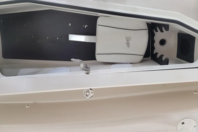 Slide: The Image of Interior storage compartment of 2025 Ranger 2360 Bay boat with seat cushion. - 14