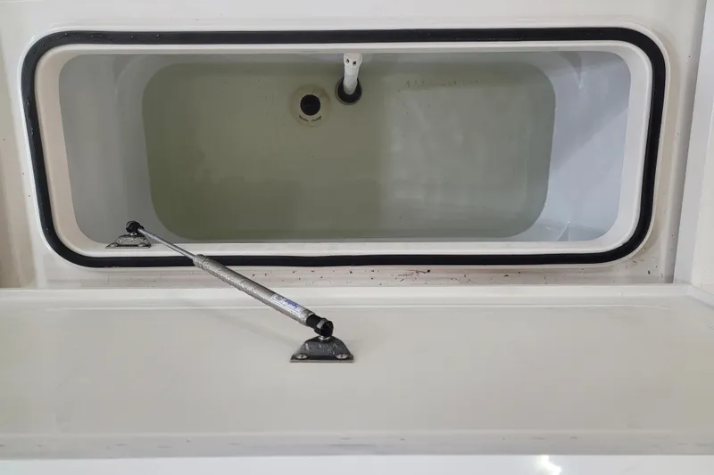 Slide: The Image of Livewell compartment of 2025 Ranger 2360 Bay boat, open lid with hydraulic support. - 15