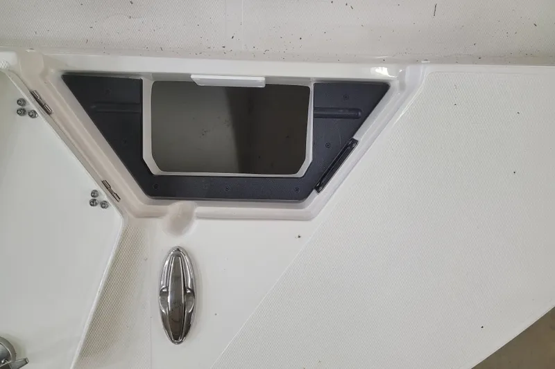 Slide: The Image of 2025 Ranger 2360 Bay boat deck with storage compartment and chrome handle. - 18