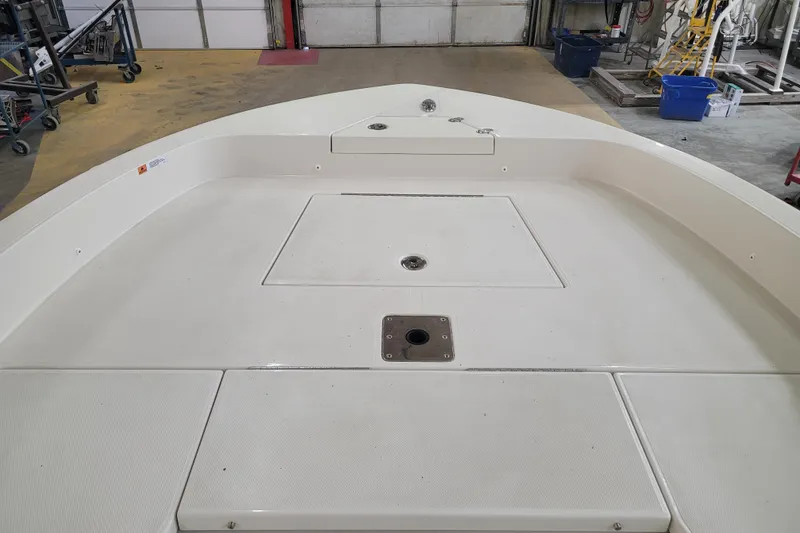Slide: The Image of 2025 Ranger 2360 Bay boat interior, spacious deck in a workshop setting. - 19