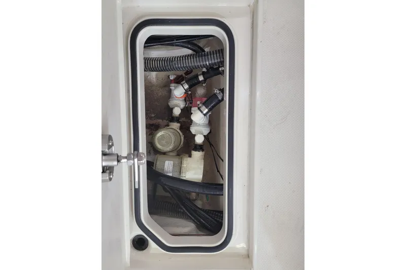Slide: The Image of 2025 Ranger 2360 Bay boat compartment with visible wiring and plumbing components. - 20