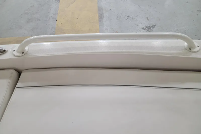 Slide: The Image of 2025 Ranger 2360 Bay boat interior with white seating and grab rail. - 24