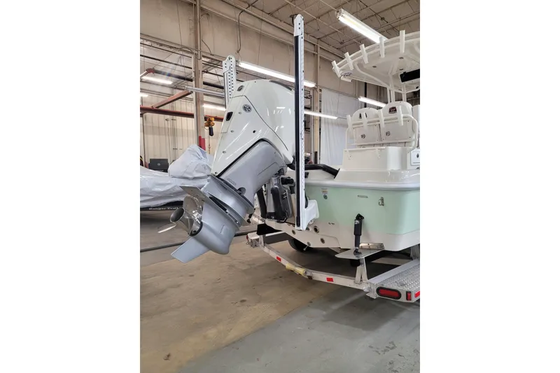 Slide: The Image of 2025 Ranger 2360 Bay boat with outboard motor in a warehouse setting. - 32
