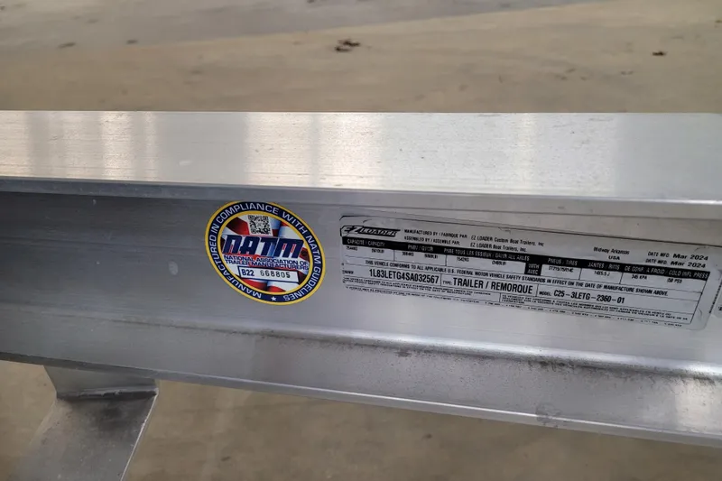 Slide: The Image of 2025 Ranger 2360 Bay trailer compliance label with NATM certification sticker. - 33