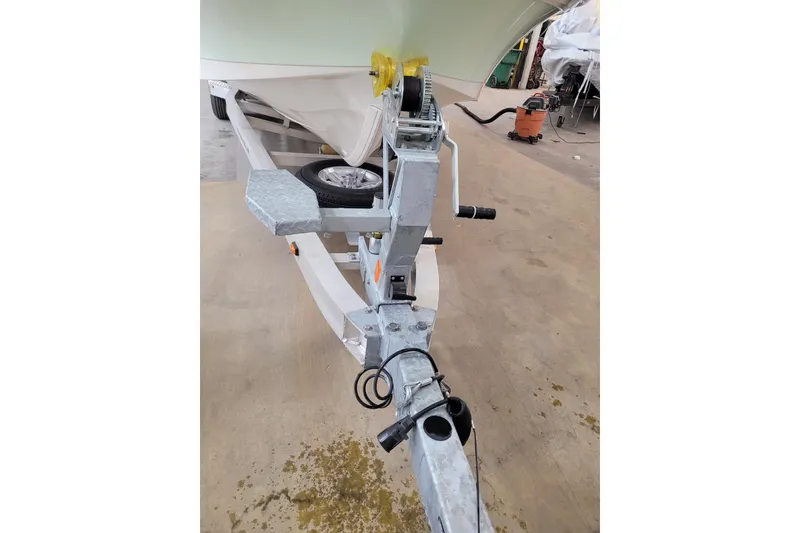 Slide: The Image of Trailer hitch of 2025 Ranger 2360 Bay boat in a workshop setting. - 34