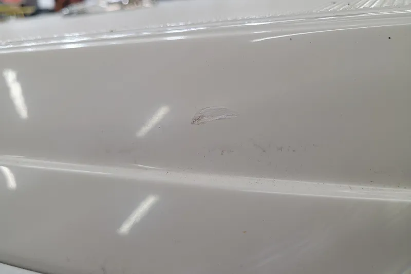 Slide: The Image of Close-up of a 2025 Ranger 2360 Bay boat surface with minor scratch. - 35