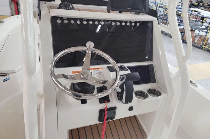 Slide: The Image of 2025 Ranger 2360 Bay boat console with steering wheel and controls. - 9