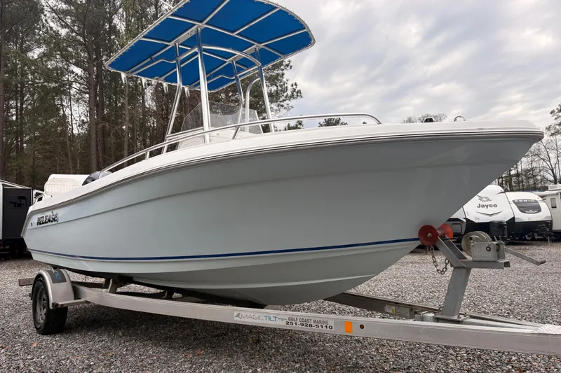 Slide: The Image of 2018 Release Boatworks 196 RK on trailer, featuring blue canopy, parked outdoors. - 3