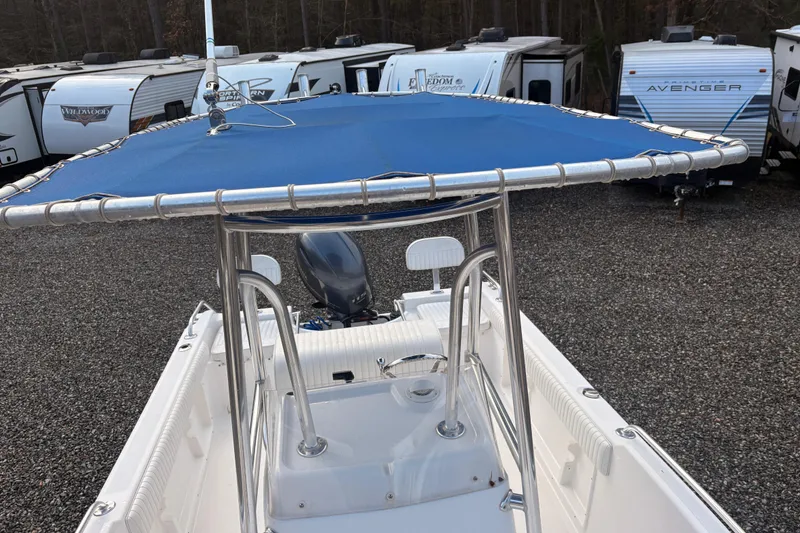 Slide: The Image of 2018 Release Boatworks 196 RK with blue canopy, parked near RVs. - 7