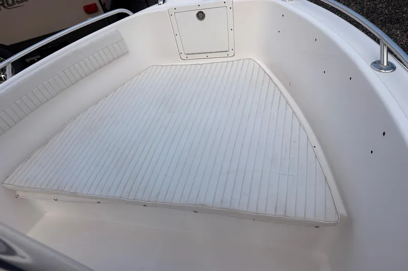 Slide: The Image of 2018 Release Boatworks 196 RK interior with cushioned seating and storage compartment. - 9