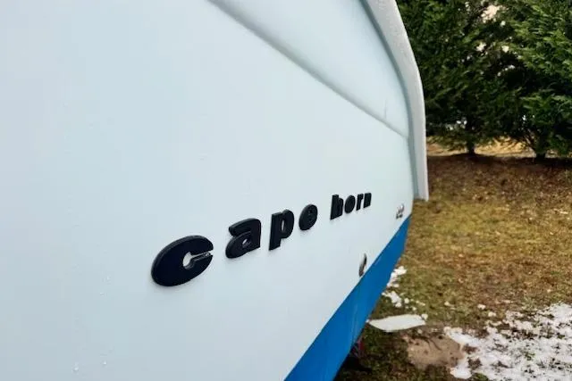 Slide: The Image of 2018 Cape Horn 36 XS boat side view with logo, on grassy area. - 5