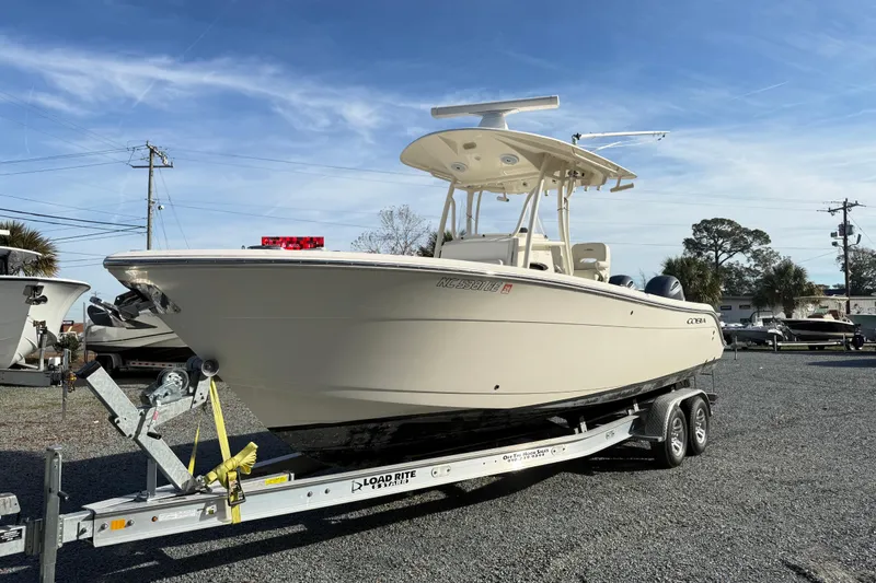 The Image of 2017 Cobia boat on trailer under clear blue sky. - 1