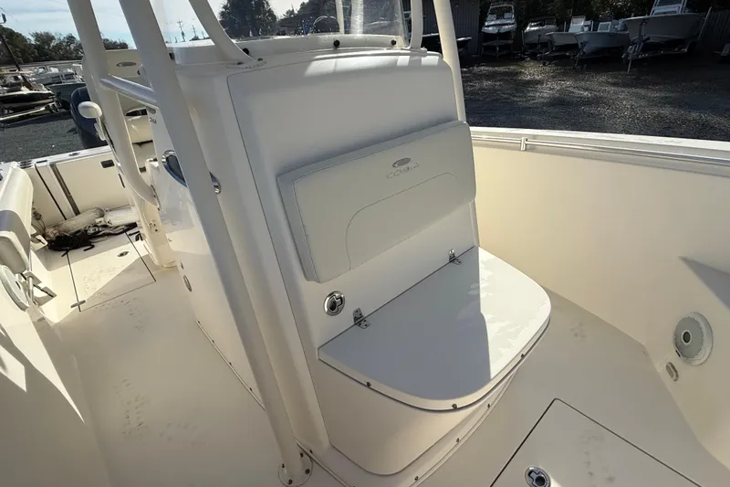 Slide: The Image of 2017 Cobia boat interior with seating and storage, parked in a marina. - 4