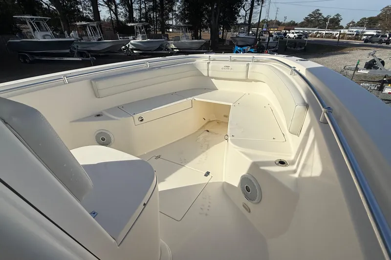 Slide: The Image of 2017 Cobia boat interior with seating and storage, parked outdoors. - 5