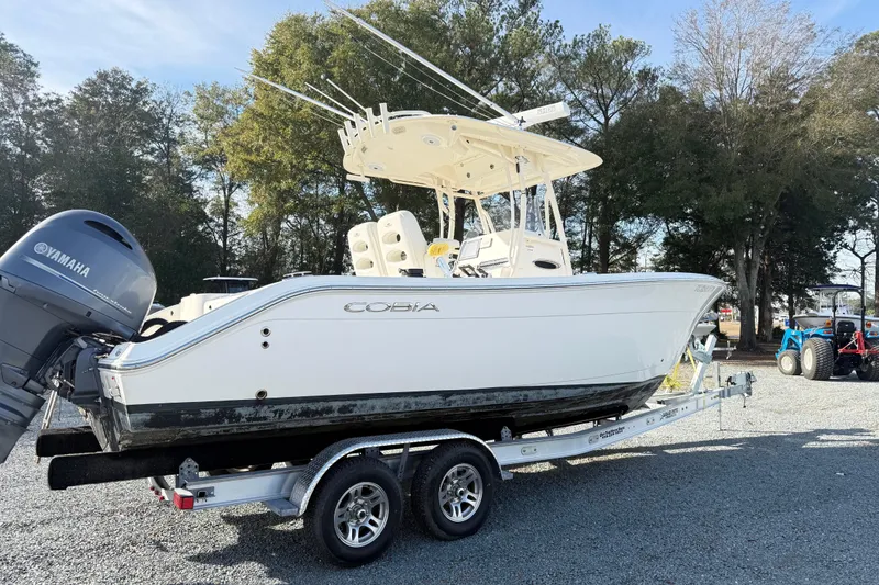 Slide: The Image of 2017 Cobia boat on trailer with Yamaha outboard motor, parked outdoors. - 6