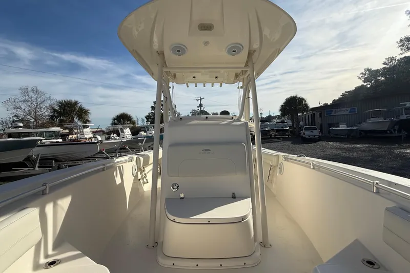 Slide: The Image of 2017 Cobia boat interior with center console, docked under a clear sky. - 7