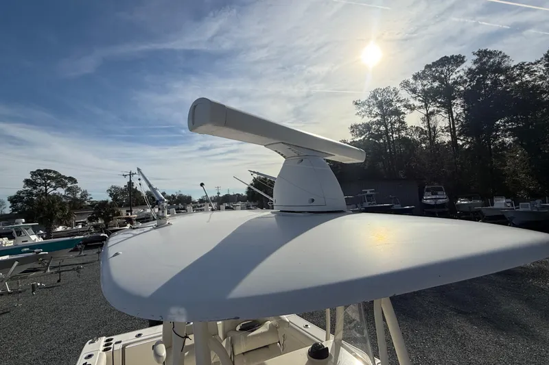 Slide: The Image of 2017 Cobia boat with radar, docked under a sunny sky. - 8
