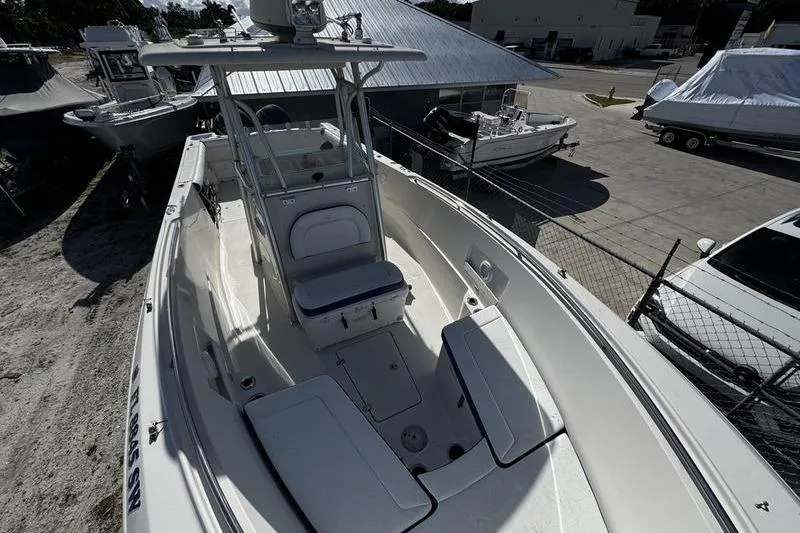 Slide: The Image of 2010 Sailfish 2860 CC boat, white interior, parked in a marina. - 12