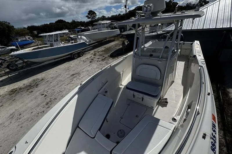 Slide: The Image of 2010 Sailfish 2860 CC boat on display, featuring spacious deck and seating. - 13