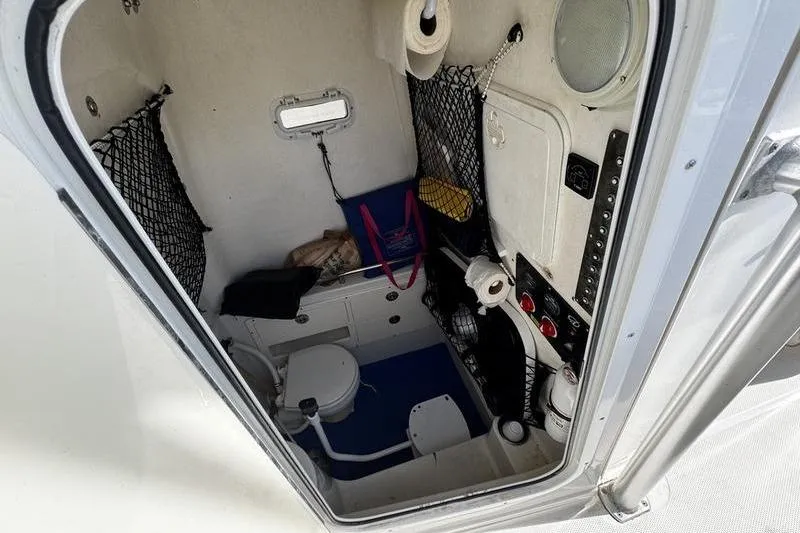 Slide: The Image of Interior of 2010 Sailfish 2860 CC boat cabin with storage and toilet facilities. - 18