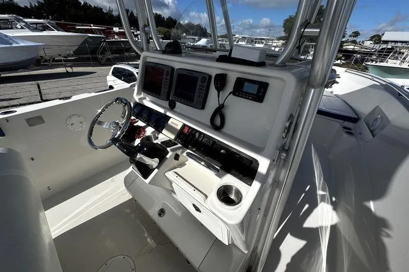 Slide: The Image of 2010 Sailfish 2860 CC boat cockpit with steering wheel and control panel. - 20