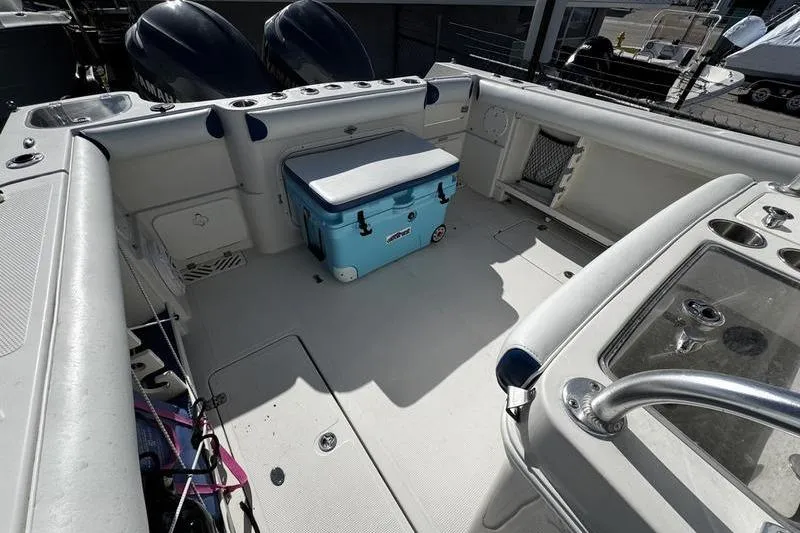 Slide: The Image of 2010 Sailfish 2860 CC boat deck with cooler and dual engines. - 23
