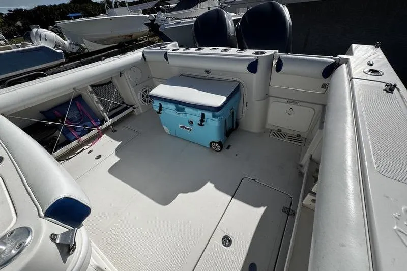 Slide: The Image of 2010 Sailfish 2860 CC boat interior with seating and a blue cooler. - 24