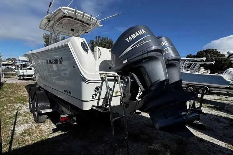 Slide: The Image of 2010 Sailfish 2860 CC boat with twin Yamaha outboard engines on a trailer. - 7