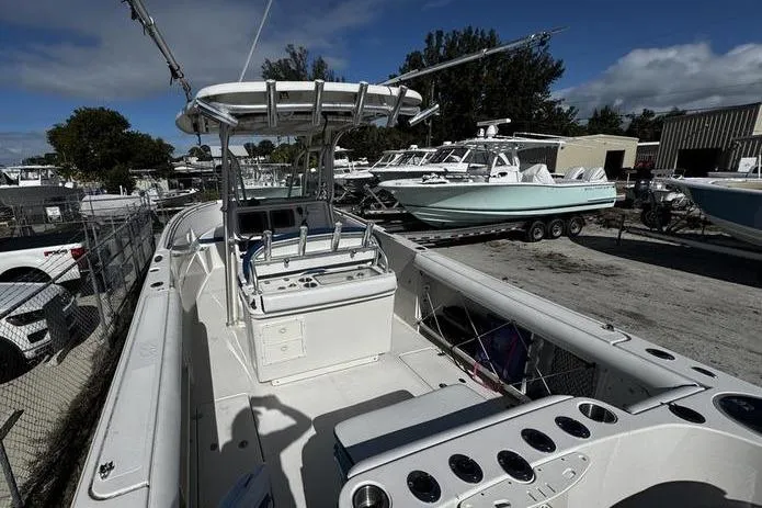 Slide: The Image of 2010 Sailfish 2860 CC boat with center console, docked in a marina under a clear sky. - 8