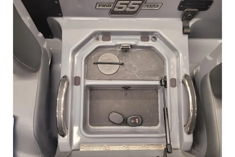 Slide: The Image of Interior of 2023 Ranger Z521R boat, featuring storage compartment and 55th anniversary badge. - 10
