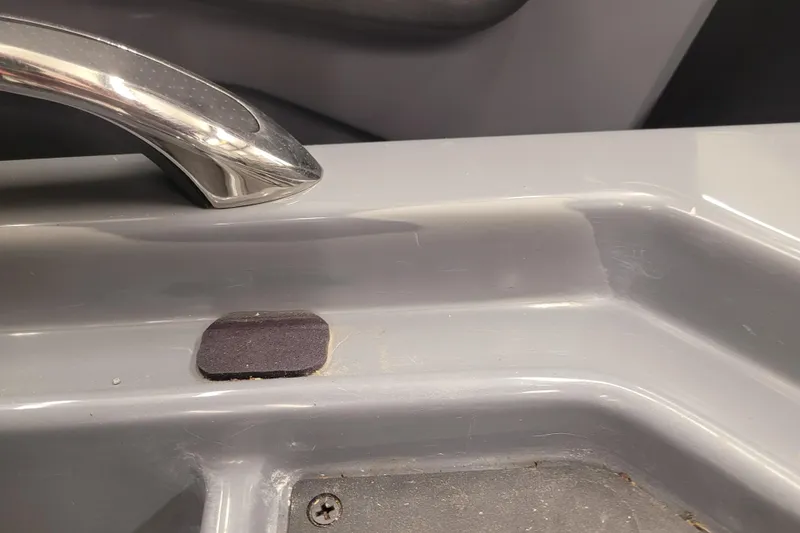 Slide: The Image of 2023 Ranger Z521R boat interior detail with chrome handle and gray surface. - 11