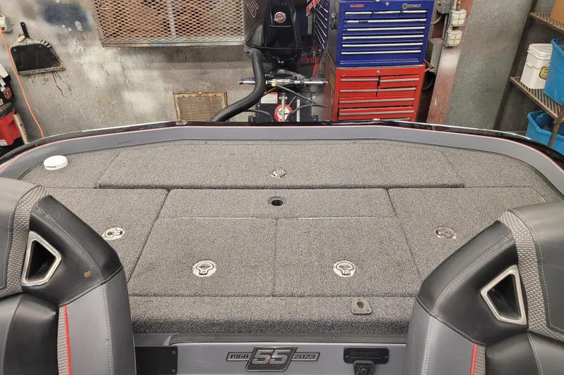 Slide: The Image of 2023 Ranger Z521R boat interior with storage compartments and seats in a workshop setting. - 12