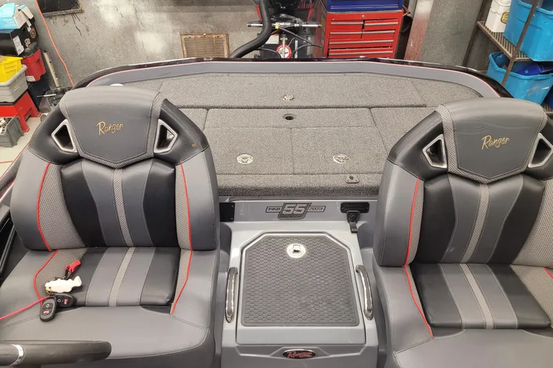 Slide: The Image of 2023 Ranger Z521R boat interior with dual seats and storage compartments. - 13
