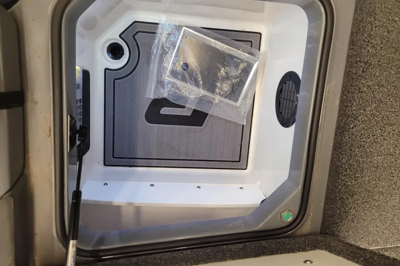 Slide: The Image of 2023 Ranger Z521R storage compartment with installed panel and packaged accessory. - 15