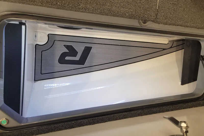 Slide: The Image of 2023 Ranger Z521R boat compartment with sleek interior design and logo detail. - 17